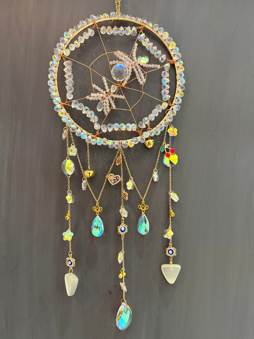 crystal spider sun catcher details of golden charms and crystals and evil eye symbol
