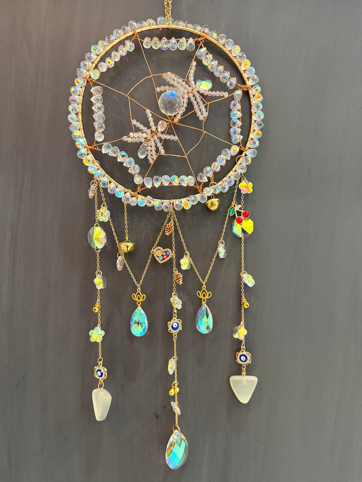 crystal spider sun catcher details of golden charms and crystals and evil eye symbol