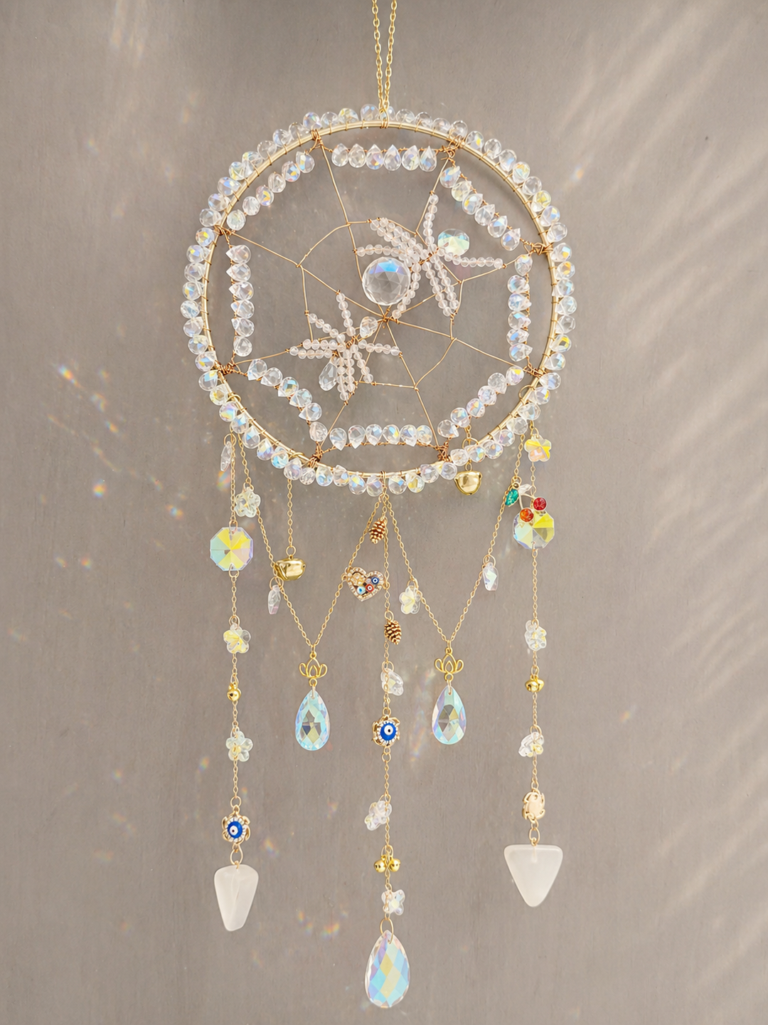 Crystal spider sun catcher hanging as spiritual wall décor in a window