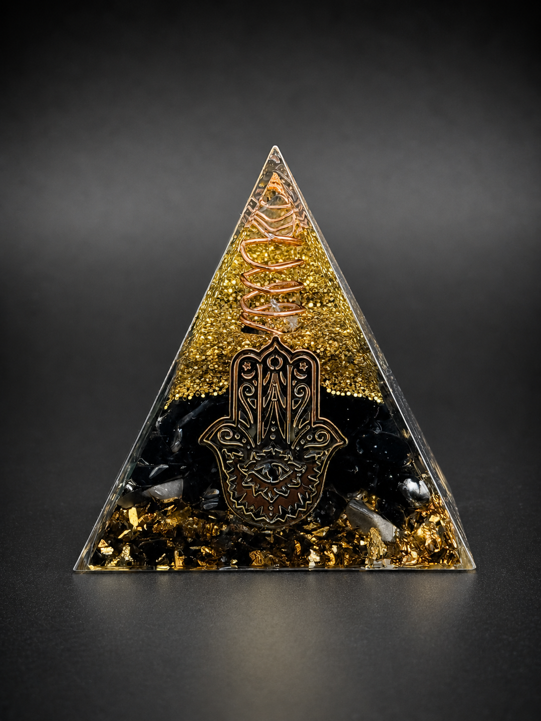 Black obsidian orgone pyramid with hamsa symbol and copper wire for protection, grounding, and energy shielding