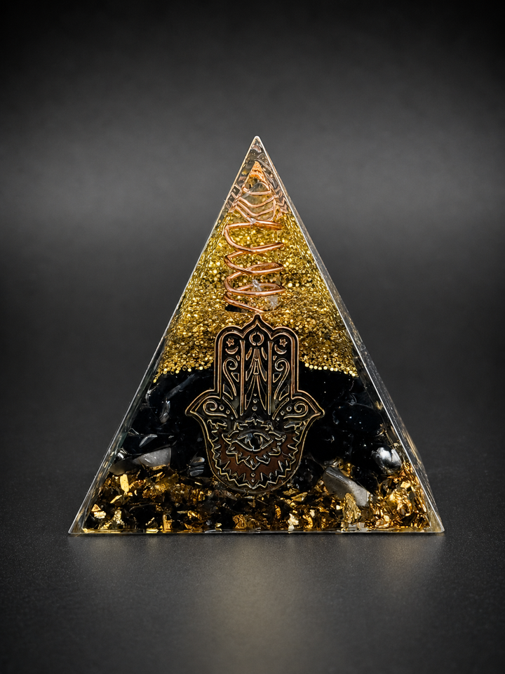 Black obsidian orgone pyramid with hamsa symbol and copper wire for protection, grounding, and energy shielding