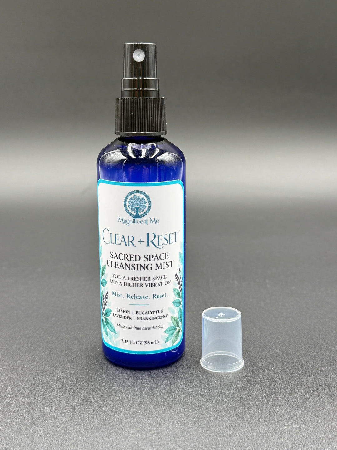 Clear + Reset Sacred Space Cleansing Mist displayed beside meditation crystals and a candle for a peaceful, intentional home ritual.